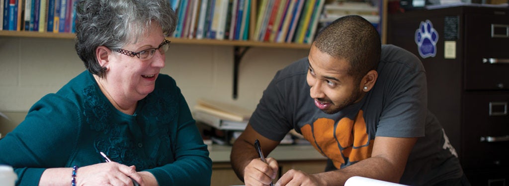 Student with Prof banner