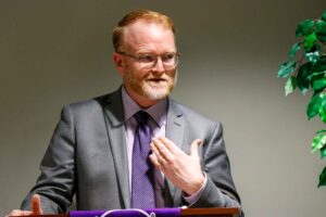 Dr. Michael Perry speaks at a Rockford University press conference